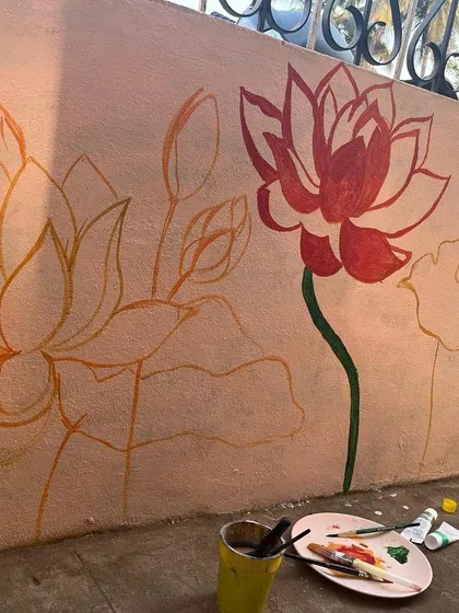The first step in my process is often sketching the design directly onto the wall. Here you can see the initial outlines for the lotus mural, which set the foundation for the painting.