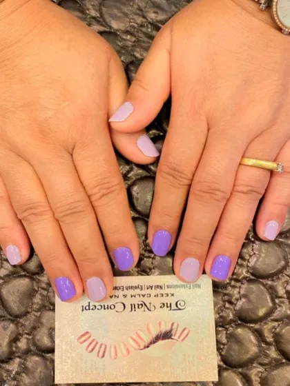 A cute and simple multi-color manicure on short, natural nails. The design alternates between a soft lavender and a lighter pastel purple.