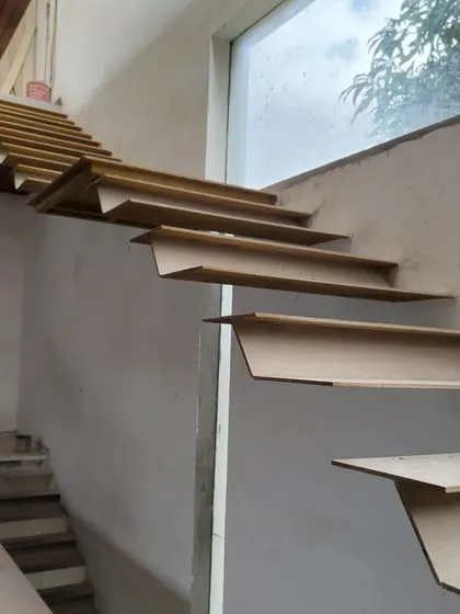 The 'House of Reddys' features a floating staircase, seen here in its raw metal form before being clad in wood.