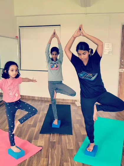 Using blocks to find stability in Tree Pose. Props are wonderful tools for helping kids build balance and confidence.