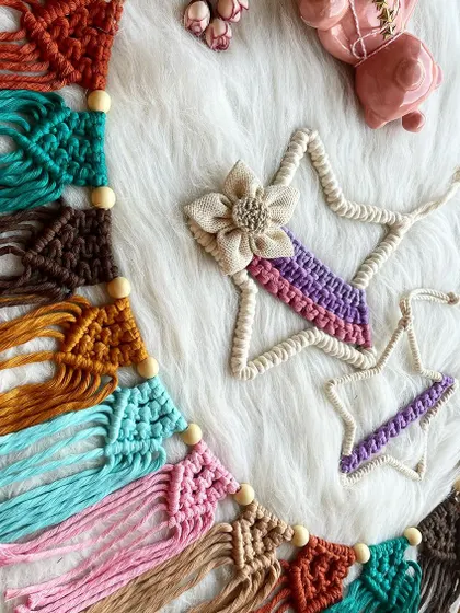 A colorful macrame bunting paired with a star ornament. This type of garland is perfect for decorating a nursery wall, a play tent, or for a birthday party.