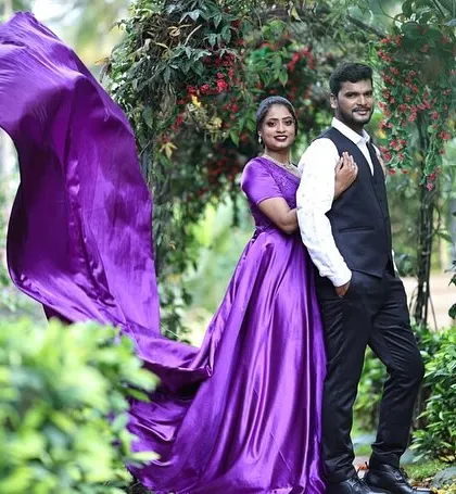 A beautiful shot of a couple in a garden, with her in our purple flying gown. We help you coordinate your outfits perfectly.