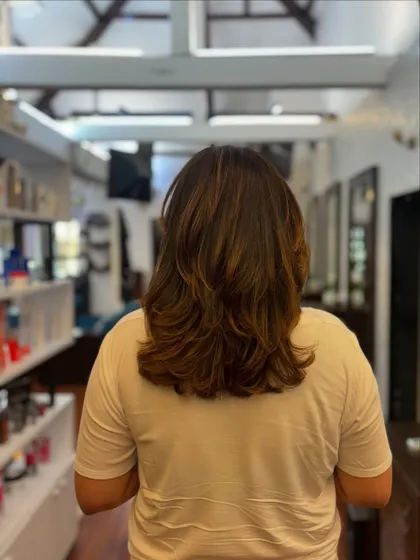 The perfect haircut to beat the heat. This mid-length cut with soft layers is stylish, lightweight, and easy to manage in warmer weather.