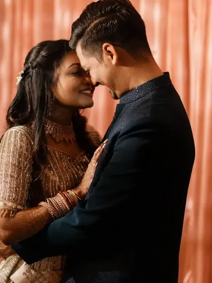 A tender embrace, their foreheads touching. This classic pose is filled with emotion, capturing a moment of peace and togetherness during their couple's portrait session.