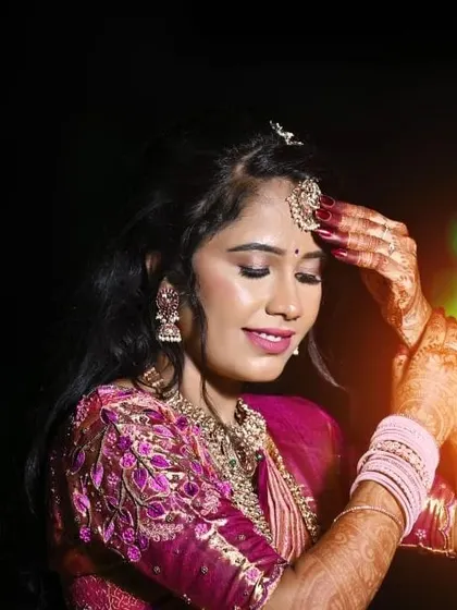 A serene and graceful portrait. The soft, shimmery eyeshadow and glowing skin give her an almost ethereal look, perfect for capturing these precious memories.