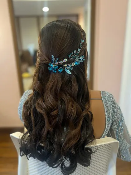 A closer look at the intricate details of the blue floral hair accessory on this beautiful half-up, half-down style.