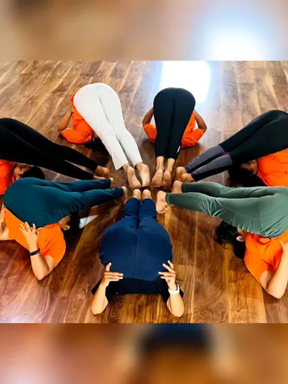 More fun with group yoga formations! These images capture the playful spirit and strong bonds forged in our training programs. It's all about connection and support.