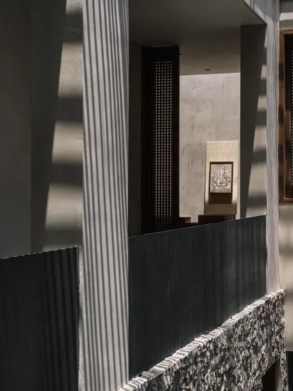 The architectural details of the courtyard, with its clean lines, natural textures, and the constant presence of light and shadow.