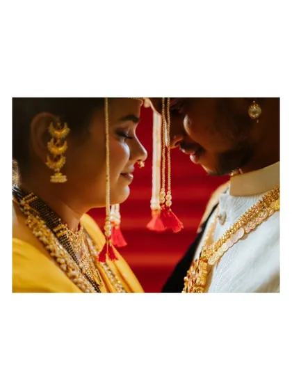 An intimate close-up of the bride and groom, highlighting the delicate 'mundavalya' and the emotional connection between them.
