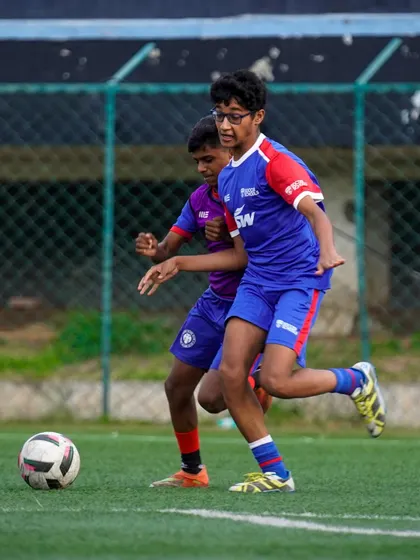 A player maintains possession while under pressure from a teammate. Our training sessions are competitive, preparing players for real match situations.