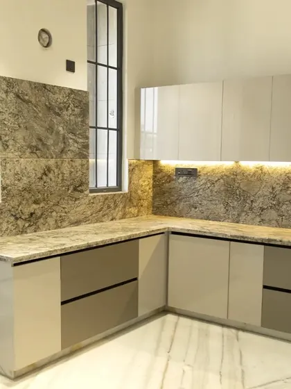 This is a preview of a modular kitchen we designed for a client in Delhi. The two-tone cabinet design in high-gloss laminate paired with a granite countertop creates a sophisticated and modern look.
