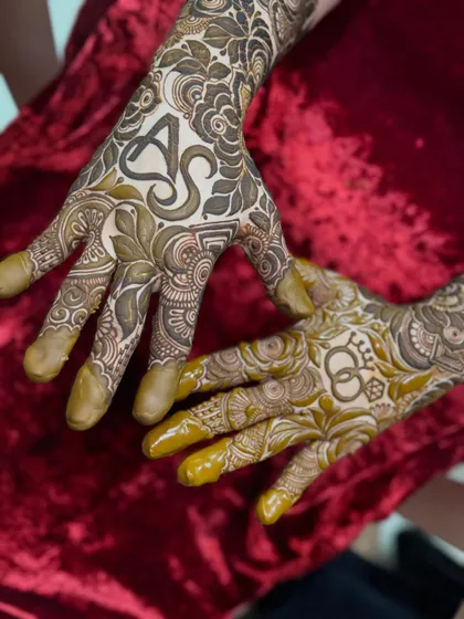 A personalized engagement design with the initials 'A' and 'S' beautifully woven into the floral pattern on the palm.