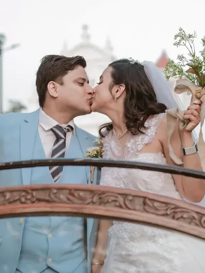 A celebratory kiss in their wedding car. A perfect, happy shot to remember the moment they officially started their journey together.