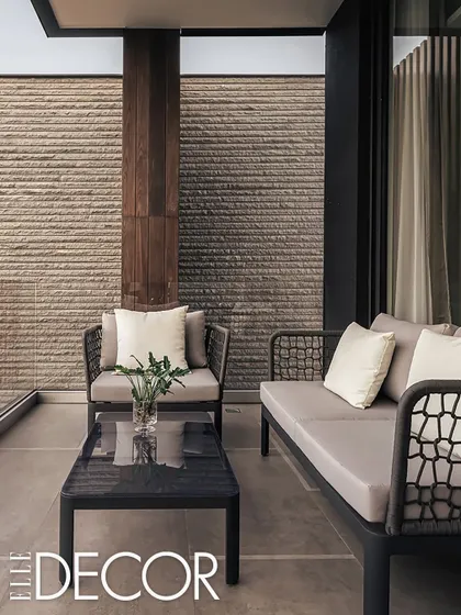 This intimate courtyard at the Carbonado residence demonstrates our focus on creating private outdoor spaces. The textured stone wall and minimalist furniture offer a serene corner for relaxation, seamlessly connected to the interior.