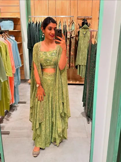 A beautiful green co-ord set with a cape-style jacket. This is a modern take on festive wear, offering a unique silhouette that is sure to turn heads.