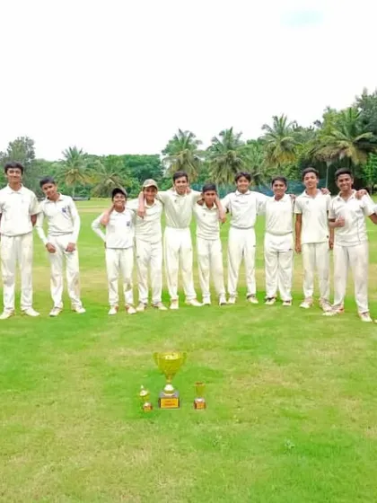 A proud team photo with their championship trophy on the field.