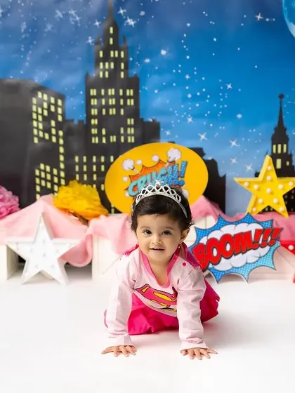 Here comes Wonder Woman! This little superhero is crawling into action in front of a dynamic city backdrop, ready to save the day.