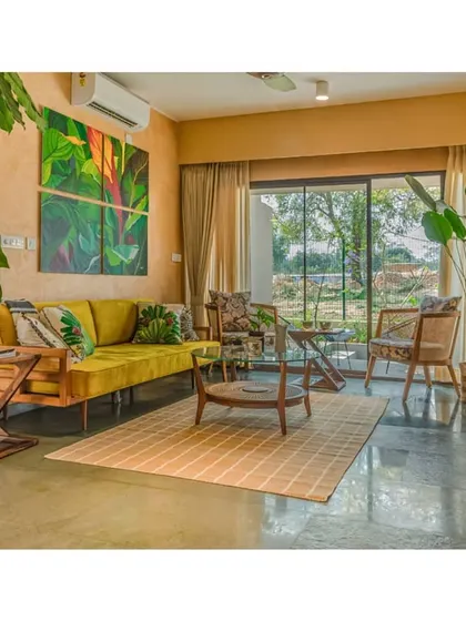 The living room opens onto a patio, seamlessly extending the living space into the garden. This indoor-outdoor connection is central to the design's focus on well-being.