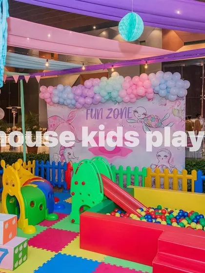 A clear view of the ball pit and slide within our rainbow play area, set against a "Fun Zone" backdrop.