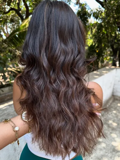 The back view of the 'Biscuit Brown' hair, styled with waves.