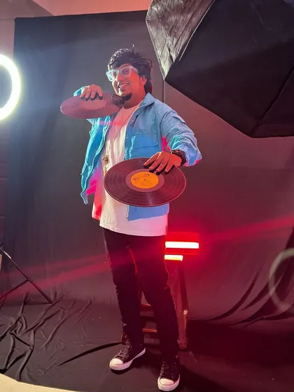 A behind-the-scenes look at a photoshoot with vinyl records and studio lighting. This captures my dedication to the craft and my dream of chasing the light.