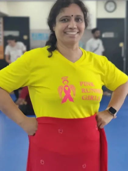A member dressed in the colors of the Kannada flag for our Rajyotsava event. Her smile says it all.