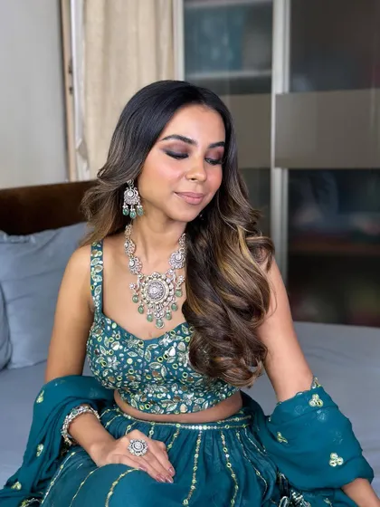 The bride with her eyes closed, showcasing the beautiful blend of the brown eyeshadows. The look is warm, sultry, and elegant.