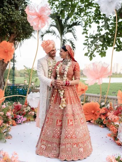 The couple posing for a photo at their beautiful outdoor wedding, looking picture-perfect.