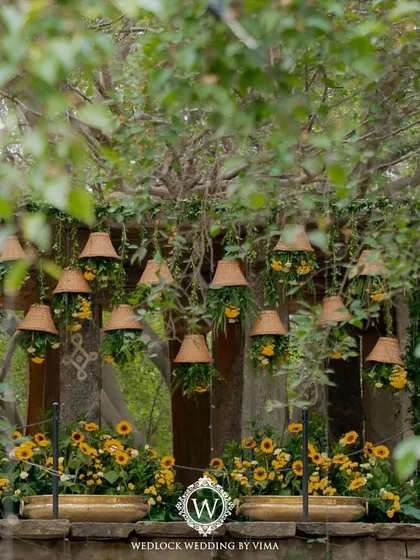 For this Haldi, we focused on a vibrant yellow theme with rustic touches. We used hanging cane baskets filled with yellow flowers, lush greens, and traditional brass urlis to create a warm and sunny celebration.
