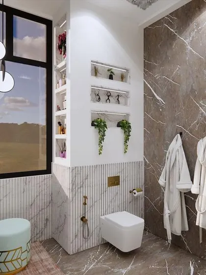 A look at the other side of the master washroom, featuring a wall-mounted toilet and built-in shelving niches for decor. The mix of white and brown marble adds texture and visual interest.