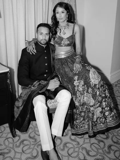 A timeless black and white portrait of Nikki & Avin. This artistic shot captures their poise and the classic glamour of their reception look.