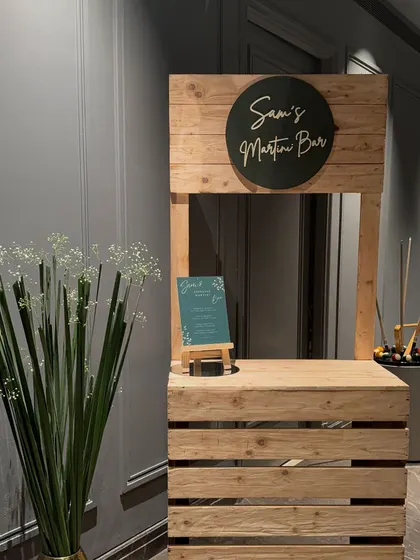 A straight-on shot of the rustic wooden bar, perfect for a custom drink station at any event.