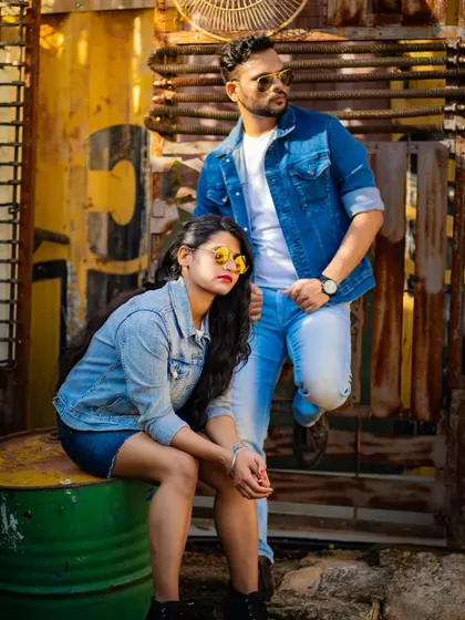 An edgy, fashion-forward pre-wedding shot in an industrial setting, perfect for couples looking for a non-traditional aesthetic.