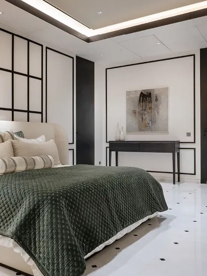A bedroom from our black-and-white themed project, featuring a custom bed and console table. The artwork adds a touch of color and personality to the monochromatic space.