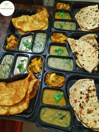 For a traditional vegetarian feast, I offer these thalis with 'Tal' (a type of dal) and 'Tal akangba' (fried bread). It's a simple, soulful meal that is full of flavor.