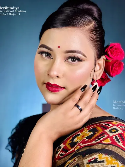 A portrait of the retro look, highlighting the clean lines of the bun and the classic placement of the floral accessory.