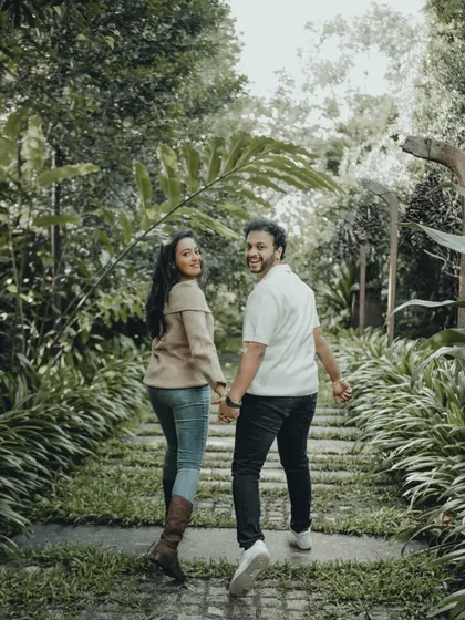 The classic "look back" shot, filled with joy and connection. This candid photo from a pre-wedding shoot captures the fun and spontaneity of the couple.