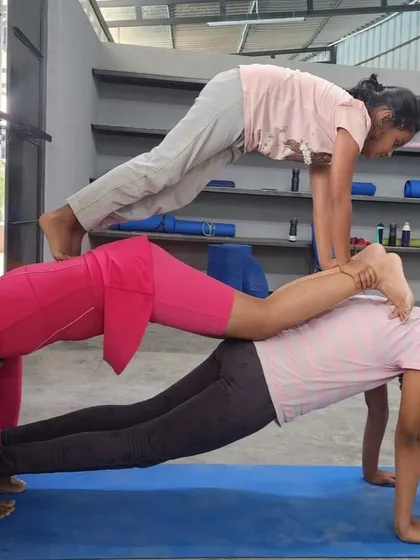 A three-person plank stack, showcasing the incredible strength and trust within this group of girls.