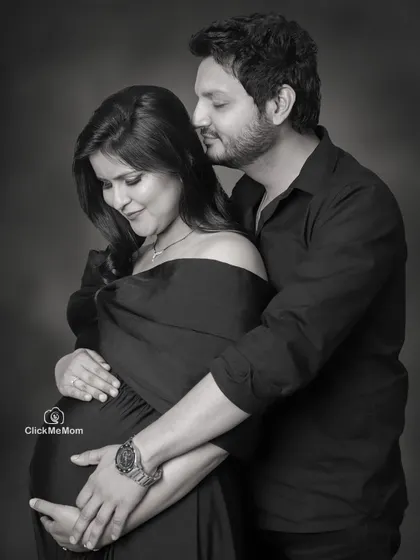 An intimate black and white portrait showing the deep bond between partners. The focus is on their gentle touch and loving expressions, creating a photo full of warmth and anticipation.