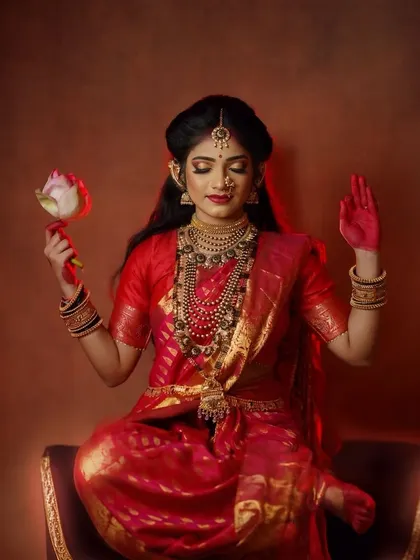A serene portrait capturing the meditative grace of the Goddess, holding a lotus flower as a symbol of purity and enlightenment in this studio concept shoot.