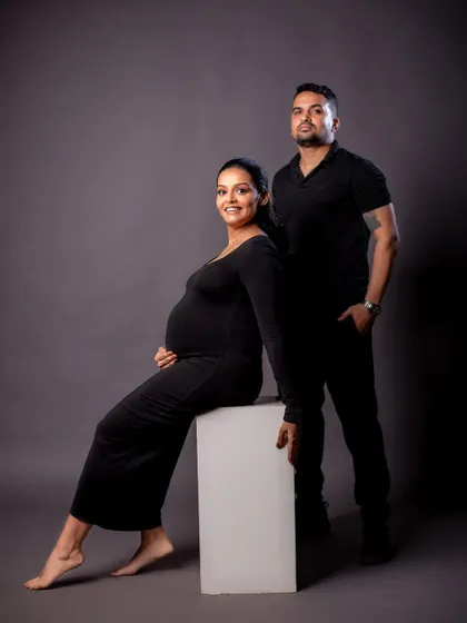 A powerful and stylish studio portrait of a couple dressed in black, exuding confidence and elegance.