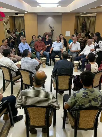 A group of colleagues sharing a moment of rhythmic connection. These sessions are designed to break down the usual workplace barriers and help people see each other in a new light.