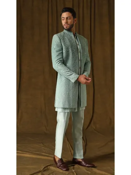 A full-length view of the 'Indian Ocean' shrug set. The gradient of cool green on the jacket, paired with matching trousers and inner kurta, creates a cohesive and visually striking look.