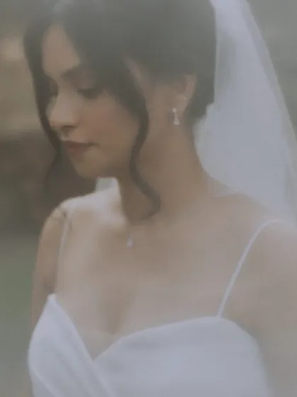 A soft and ethereal close-up portrait of the bride, capturing her delicate features and jewelry.