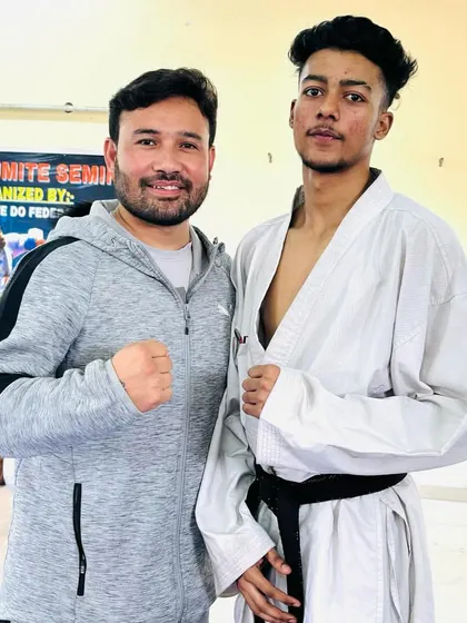 A senior student with Sensei Bobby after an advanced seminar. One on one interaction with experienced instructors helps refine individual technique.