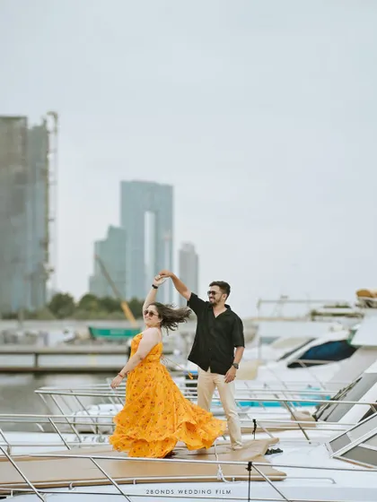 The couple shares a dance on the deck of the yacht, her dress twirling against the backdrop of the marina. A perfect cinematic moment from their destination shoot.