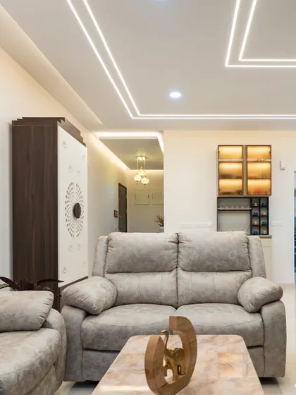 Modern and minimalist, this living room uses clean lines of profile lighting on the ceiling to create a geometric pattern that is both simple and visually striking.