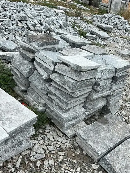 A pile of Narasapura stones, which have a natural, rustic texture. These are great for creating traditional-looking pathways and garden paving.