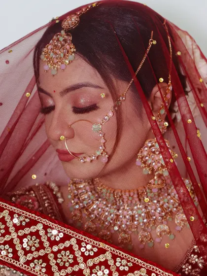 A serene shot of the bride with her eyes closed, showing the delicate shimmer on her eyelids.