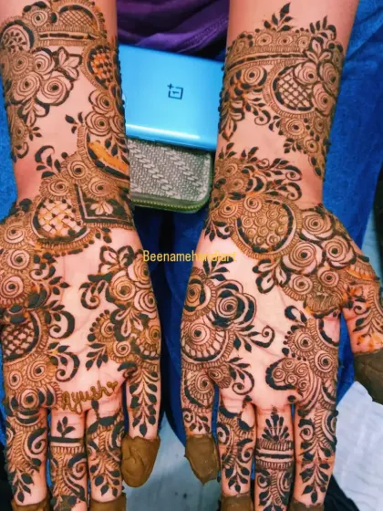 A full and dense floral mehandi design. The pattern covers the entire hand, leaving very little skin showing, which is a classic bridal style.